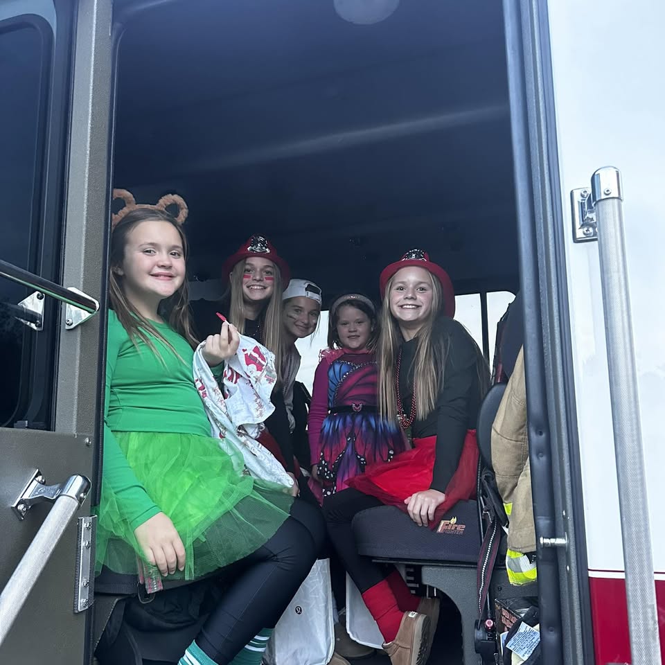 Kids in a fire truck during a community event